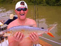 Happy angler holding up his prize Tigerfish
