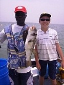 Dylan Toy and Captain Michael hold up their butterfish catch